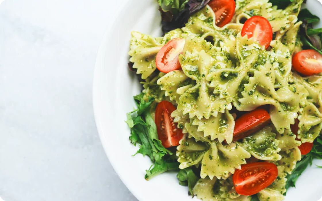 Photo of pasta with basil and tomatoes